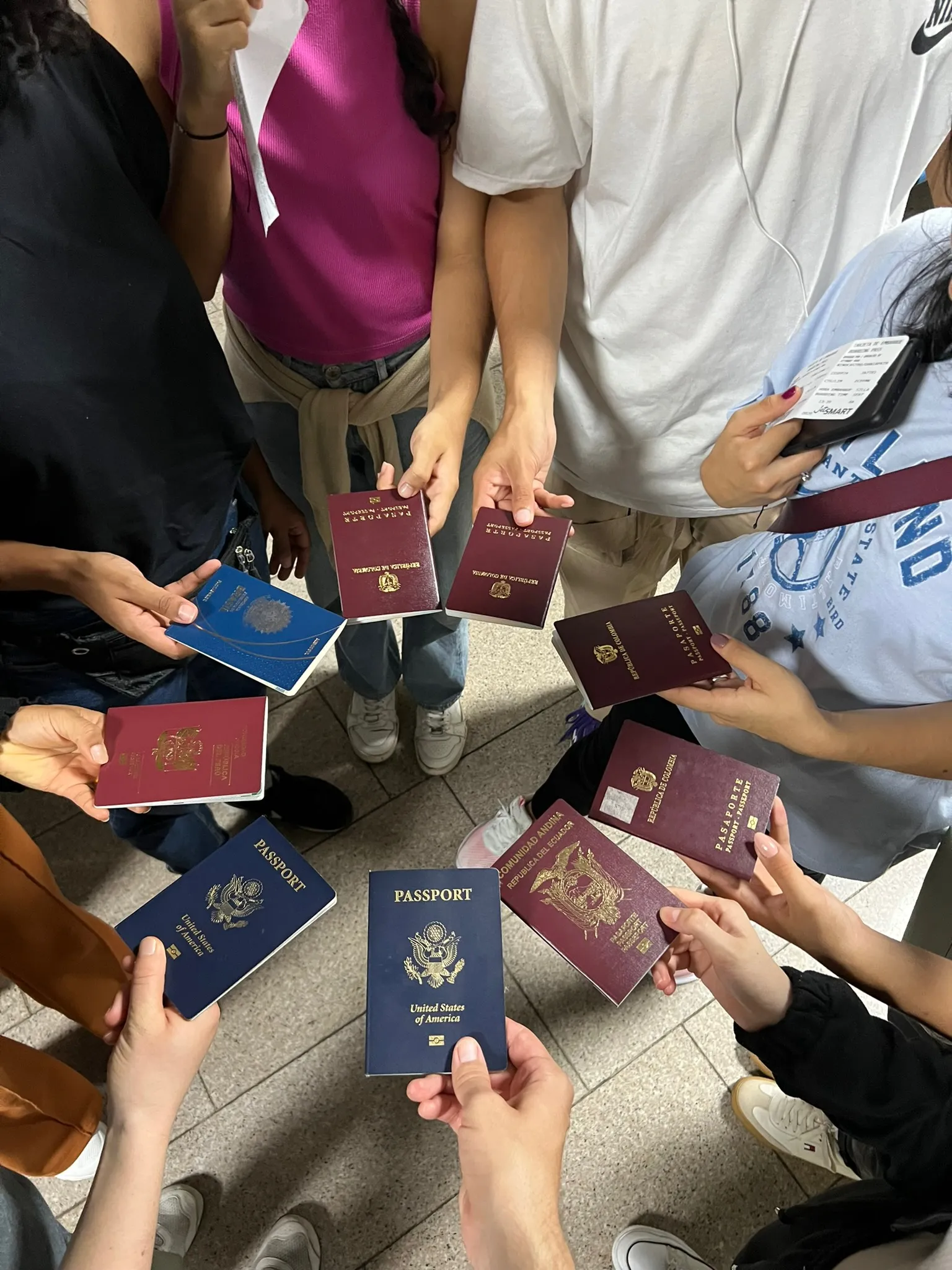 Group of people holding passports, representing going to the nations